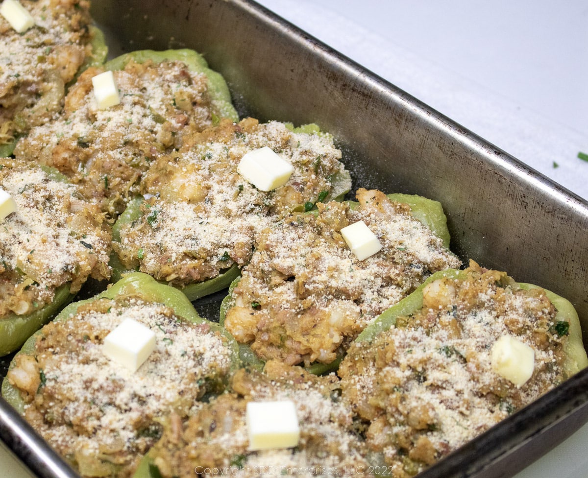 stuffed mirlitons in a baking dish ready for the oven