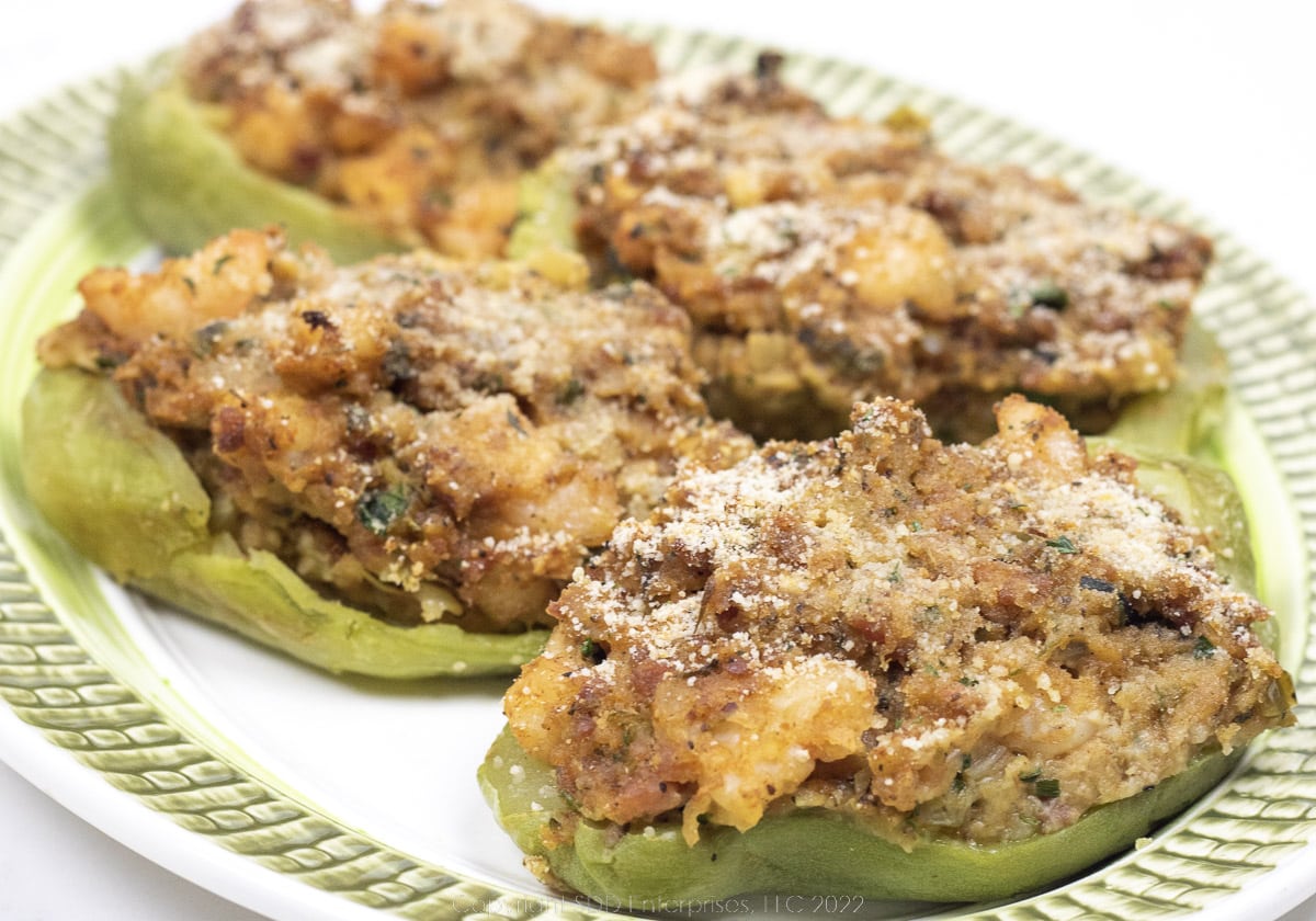 Four stuffed mirlitons on a white and green platter