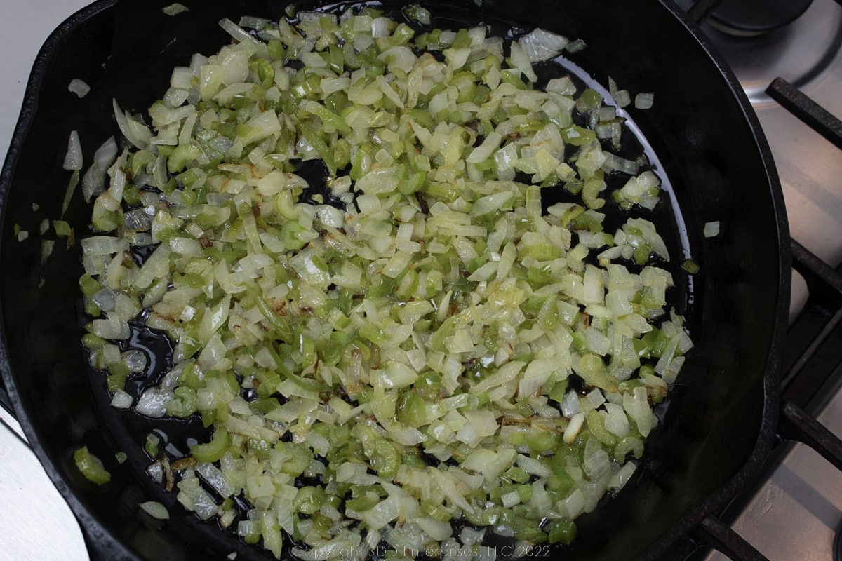 frying the trinity in butter in a cast iron skillet