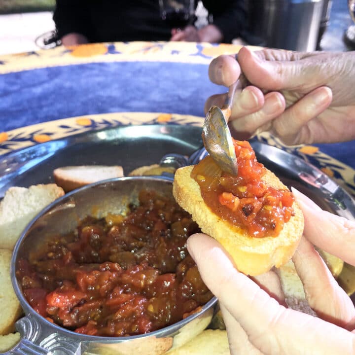 tomato bacon jam being spread on a cracker