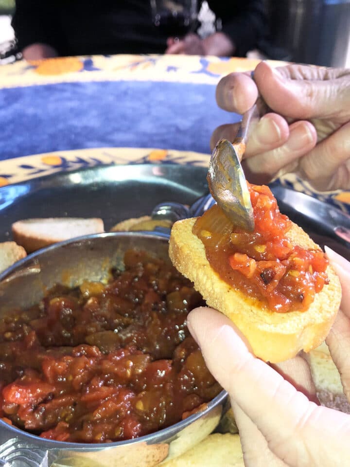 tomato bacon jam being spread on a cracker