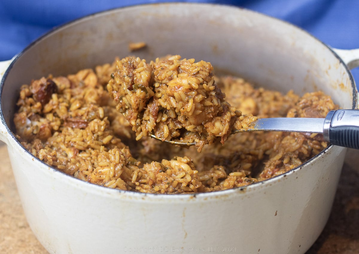 Creole Jambalaya with a serving spoon in a Dutch oven