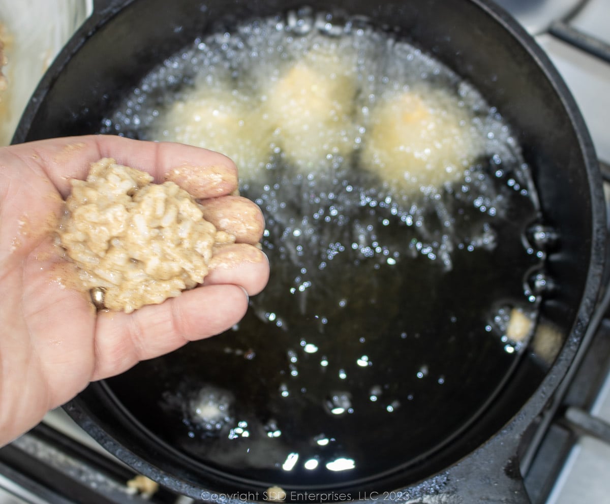 rolling a ball of calas batter by hand