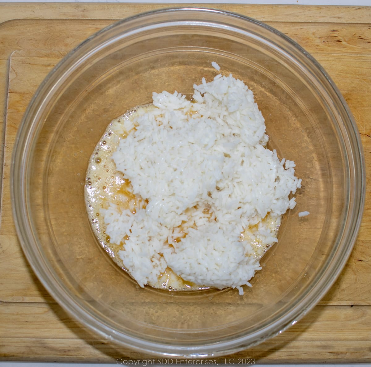 scrambled eggs, sugar and rice in a glass bowl