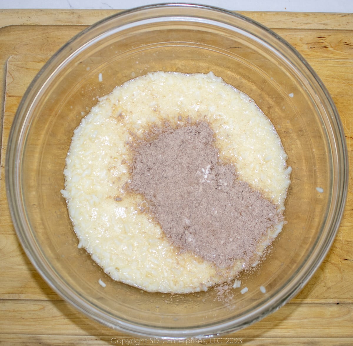 spices added to an egg-rice mixture in a glass bowl