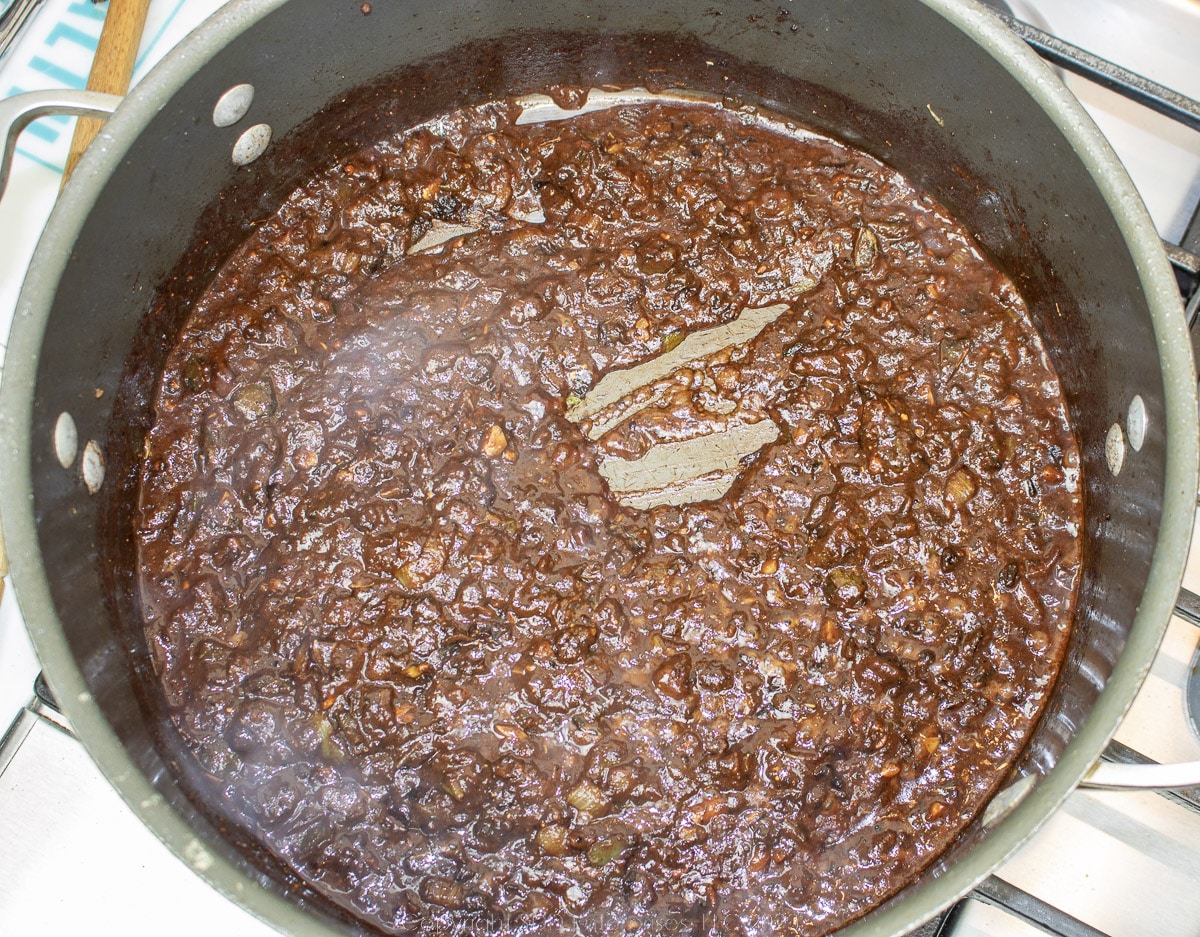 wine mixed into cooked trinity with roux and tomato paste