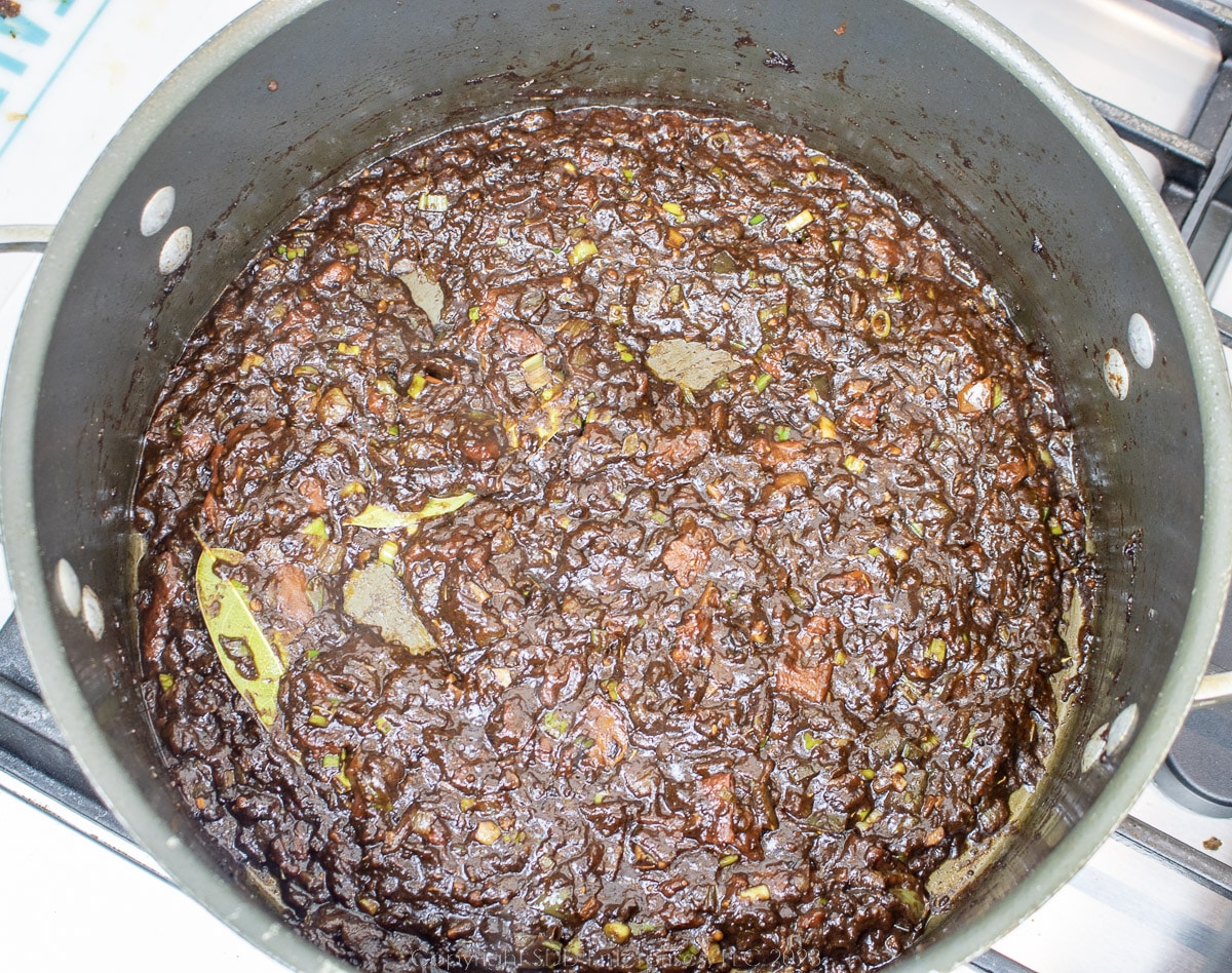 paste of tomatoes, roux and trinity in a dutch oven