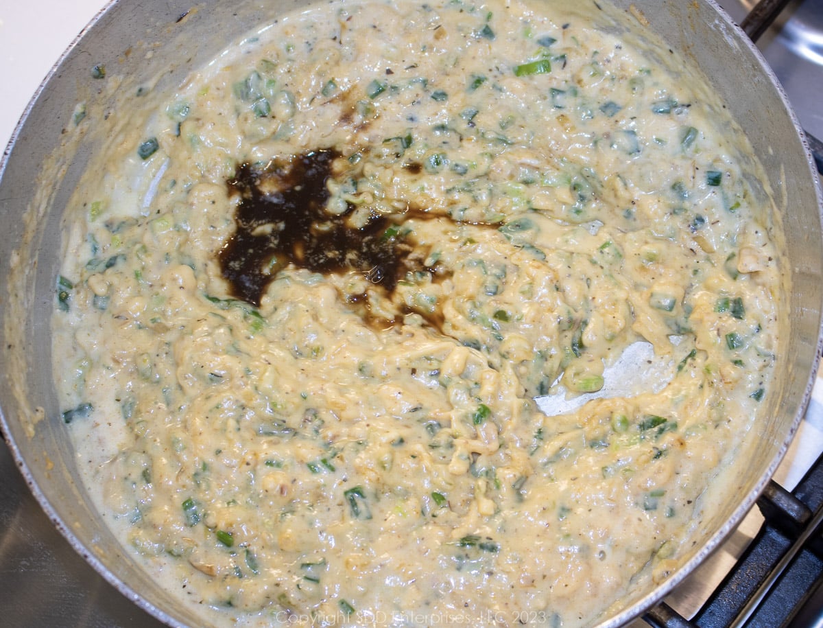 Worcestershire sauce added to the cream sauce in a frying pan