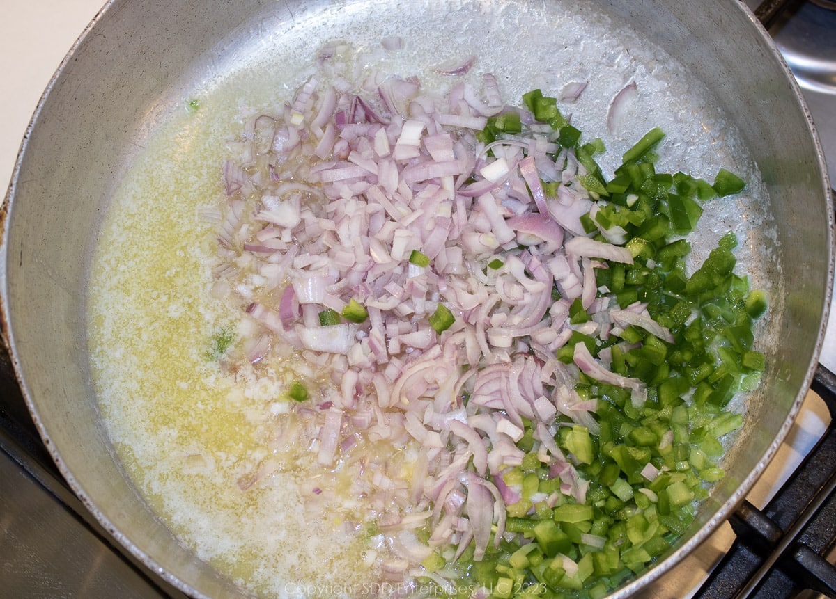 onions, celery and bell peppers sautéing in butter