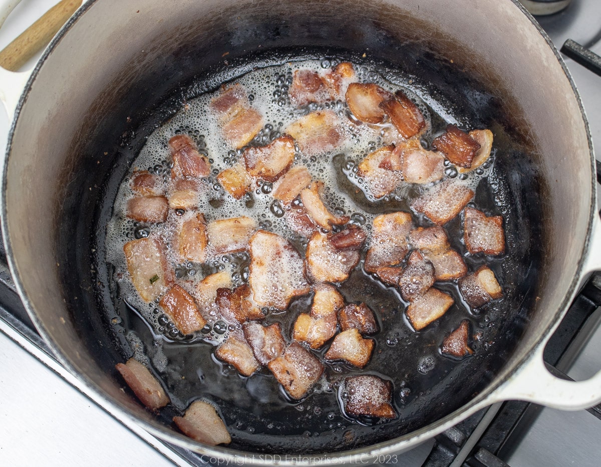 bacon frying in a Dutch oven