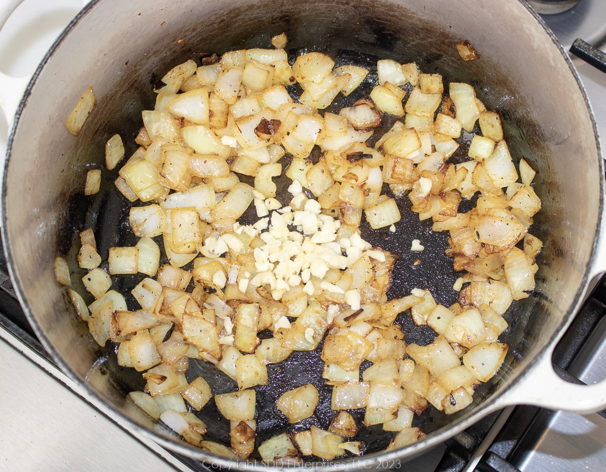 garlic added to frying onion in a Dutch oven