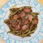 creole green beans on a green-blue plate