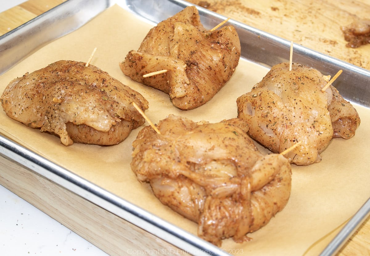 seasoned chicken breasts wrapped around filling and secured with tooth picks