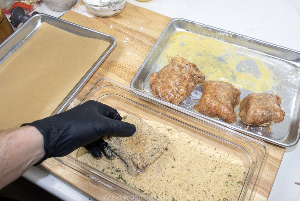 Egg wash and breadcrumbs added to stuffed chicken breasts