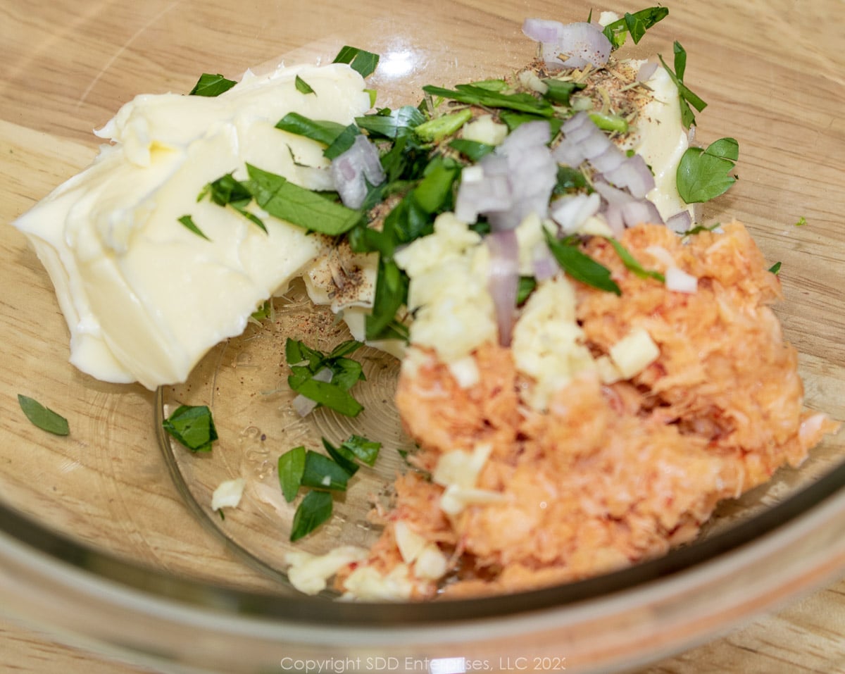 ingredients for crawfish compound butter added to a glass bowl