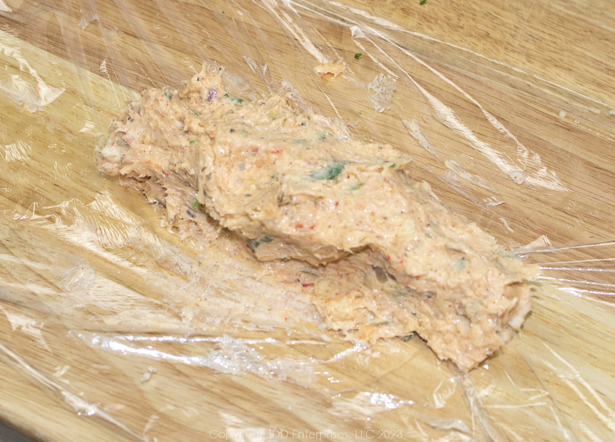 mixed crawfish compound butter on a sheet of plastic wrap