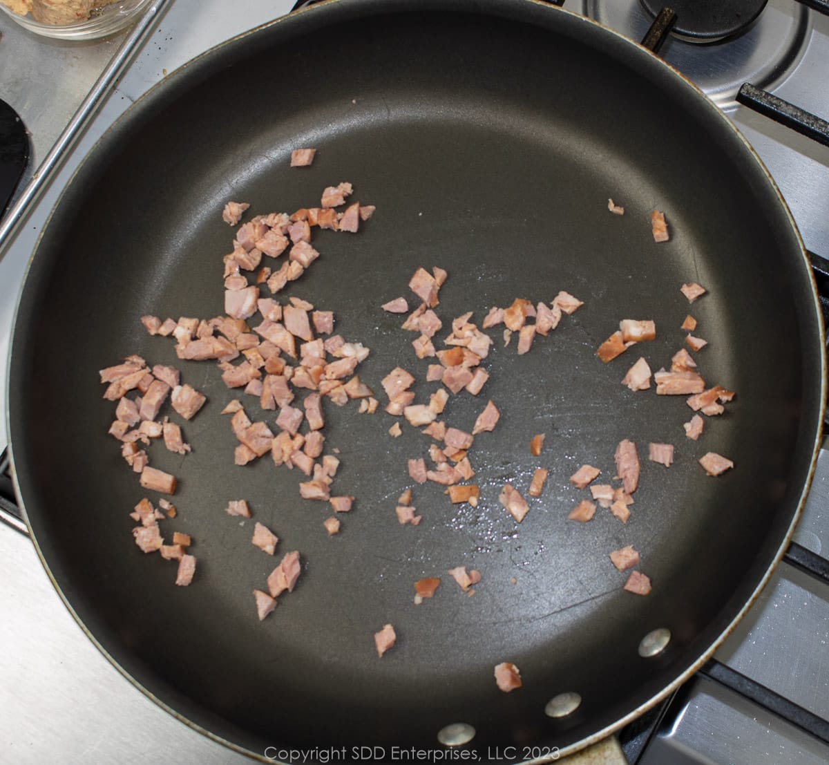 chopped andouille sausage frying n a saute pan