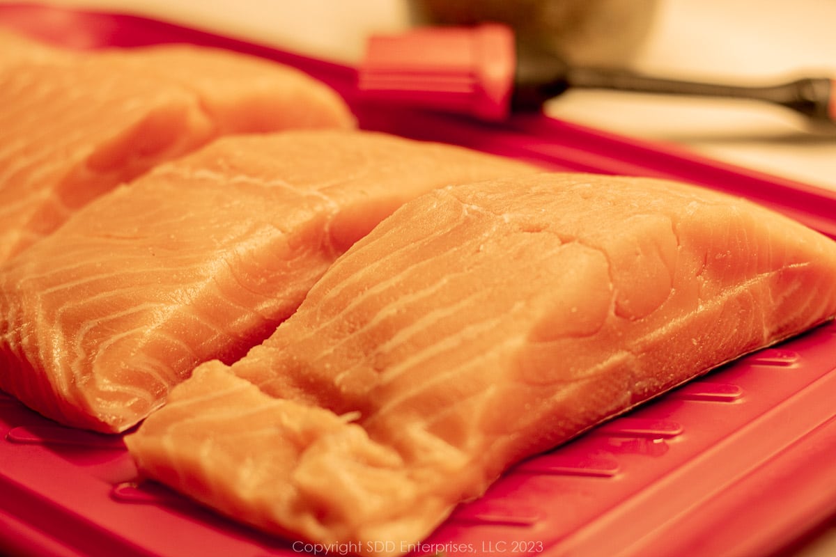salmon fillets on a red platter