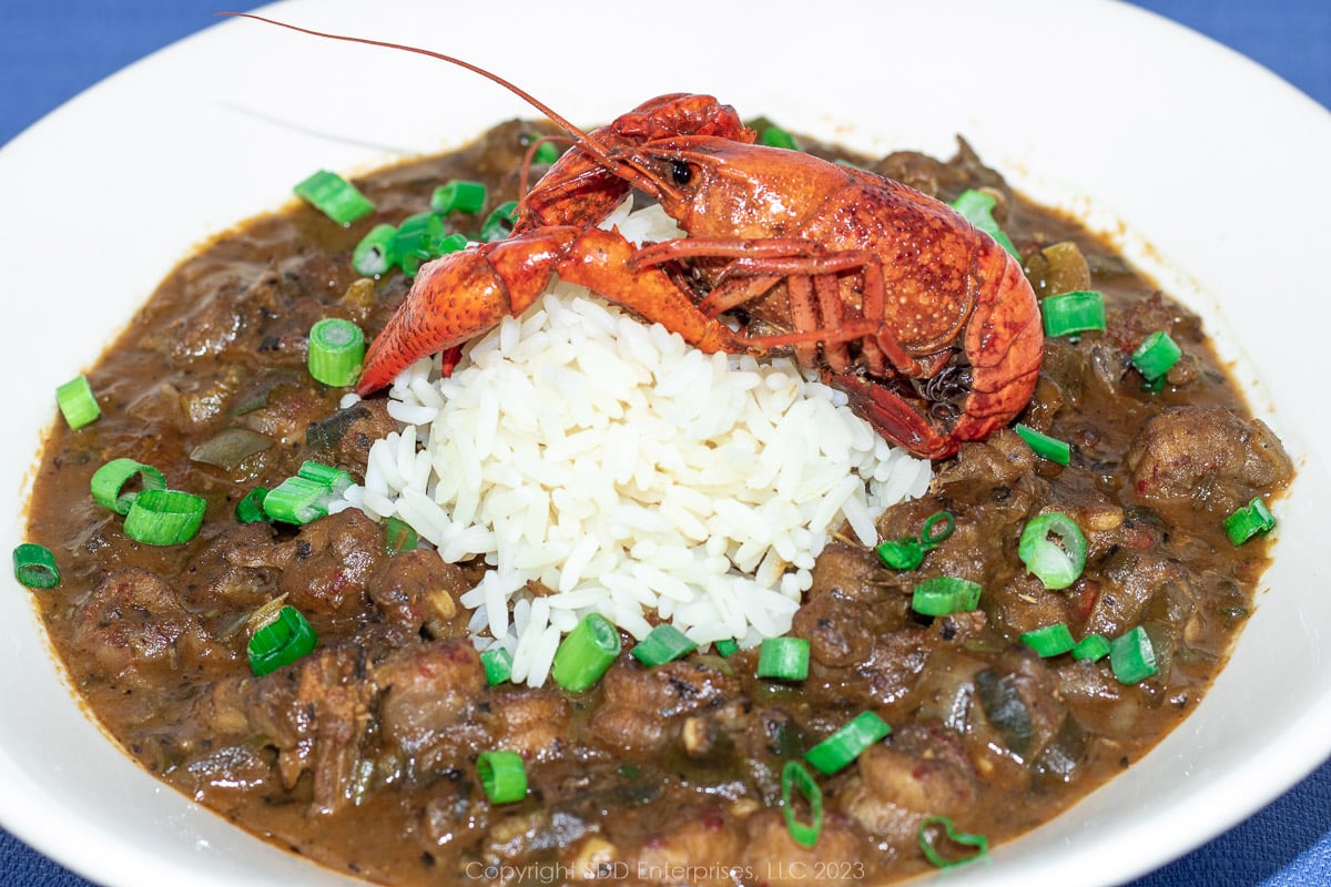 Crawfish Étouffée with rice in a bowl with a crawfish for garnish