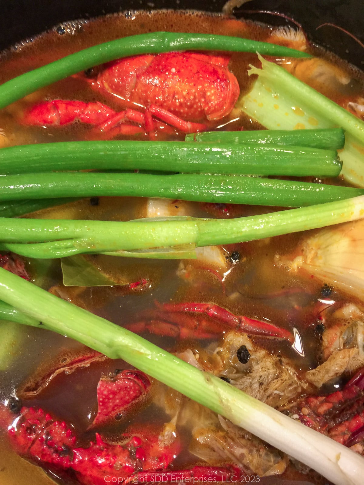 ingredients for homemade crawfish stock in a stockpot