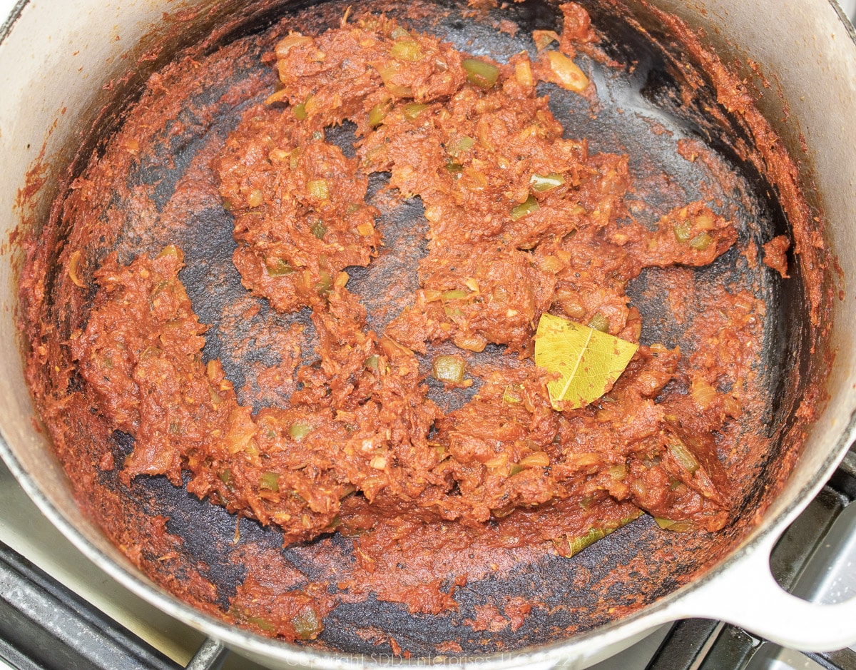 tomato paste frying on a Dutch oven