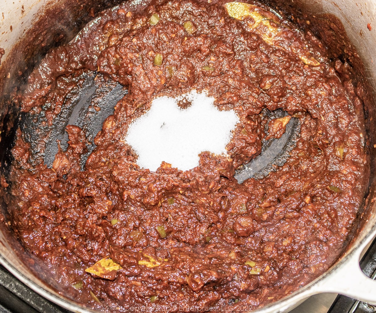 sugar with fried tomato paste in a Dutch oven