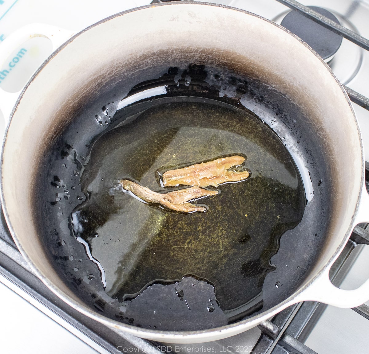Anchovy fillets in olive oil in a Dutch oven