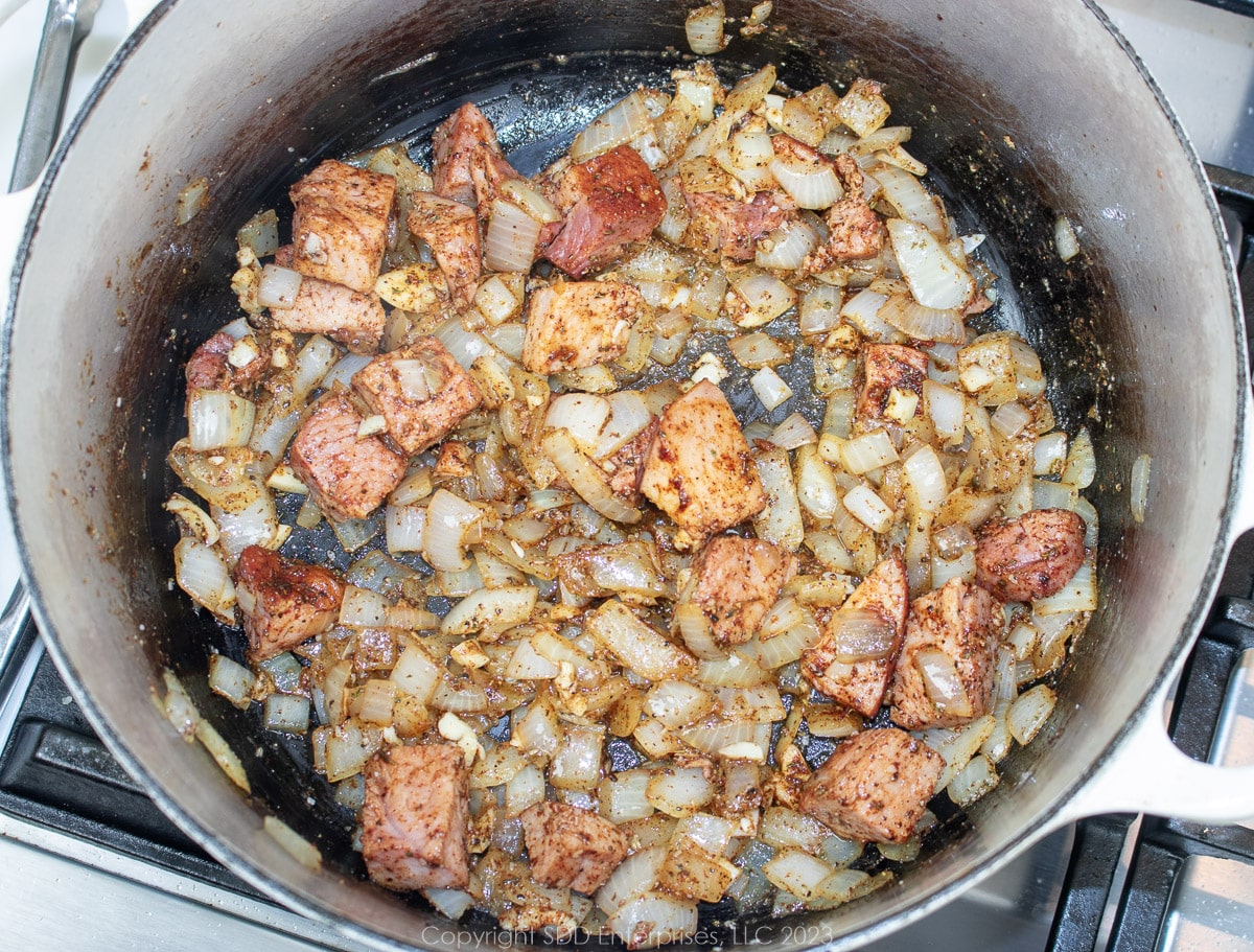 Onions, ham and seasonings mixed together in a Dutch oven