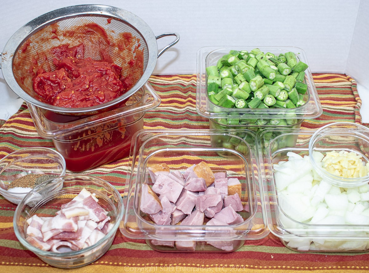 prepared ingredients for smothered okra and tomatoes in prep bowls