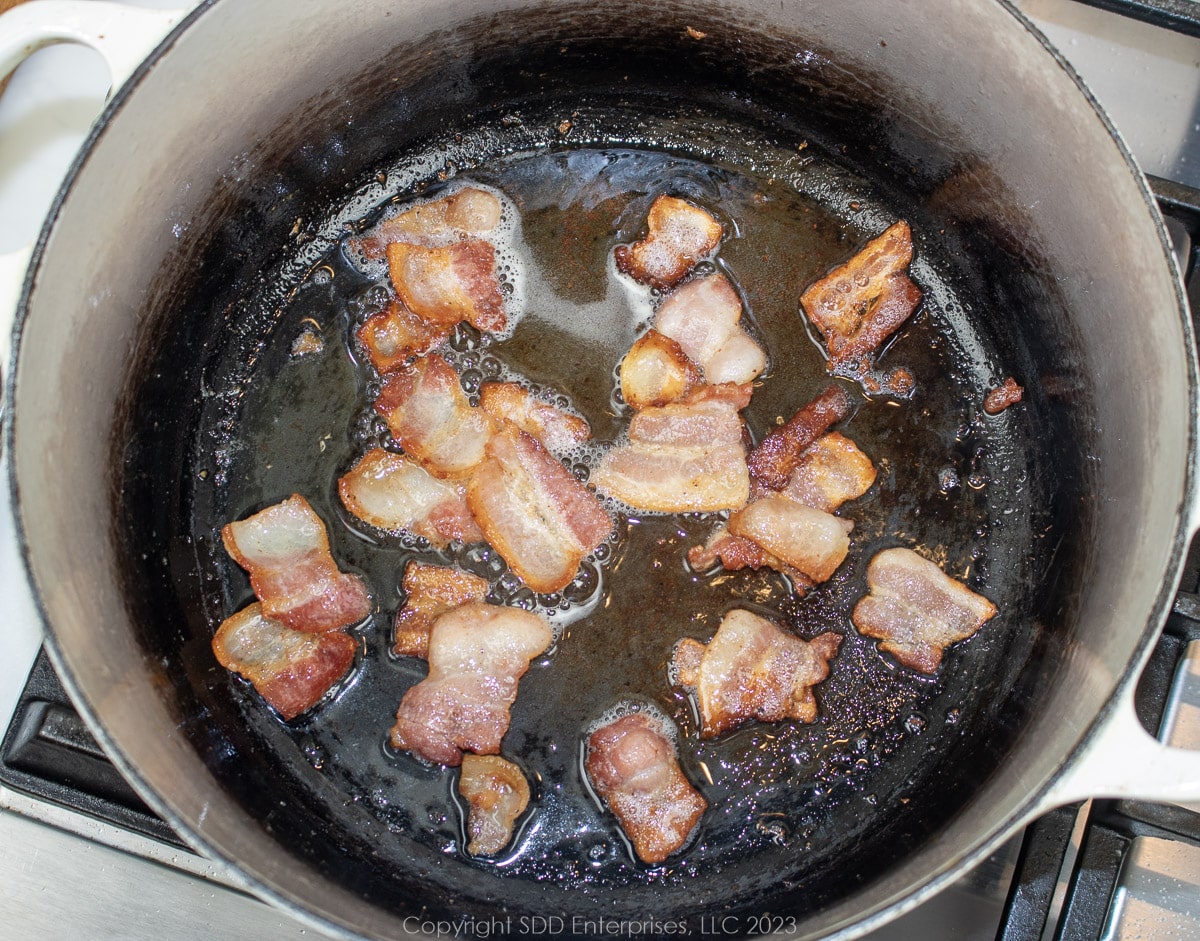 bacon frying in a Dutch oven