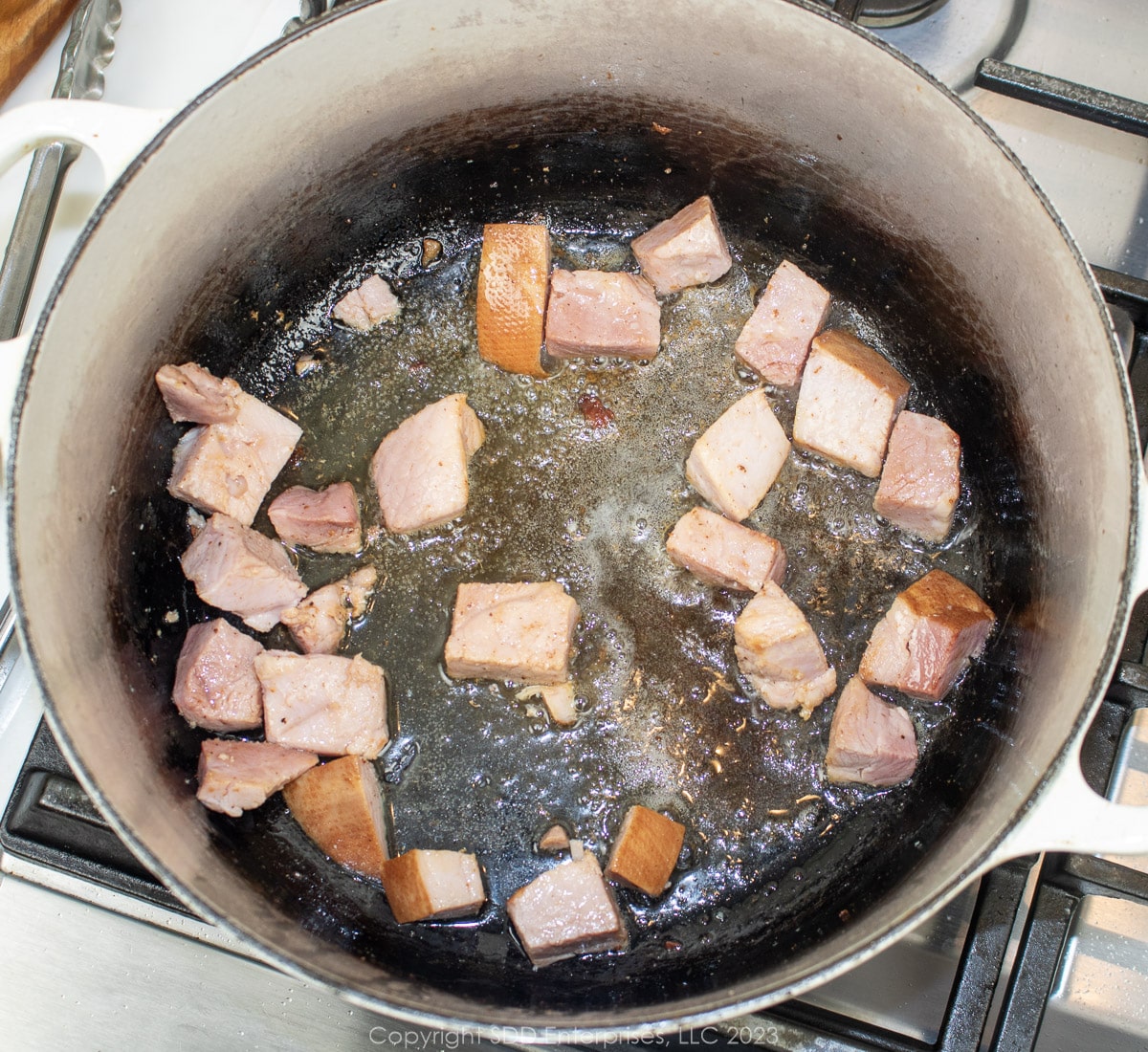 smoked ham pieces browning in a Dutch oven