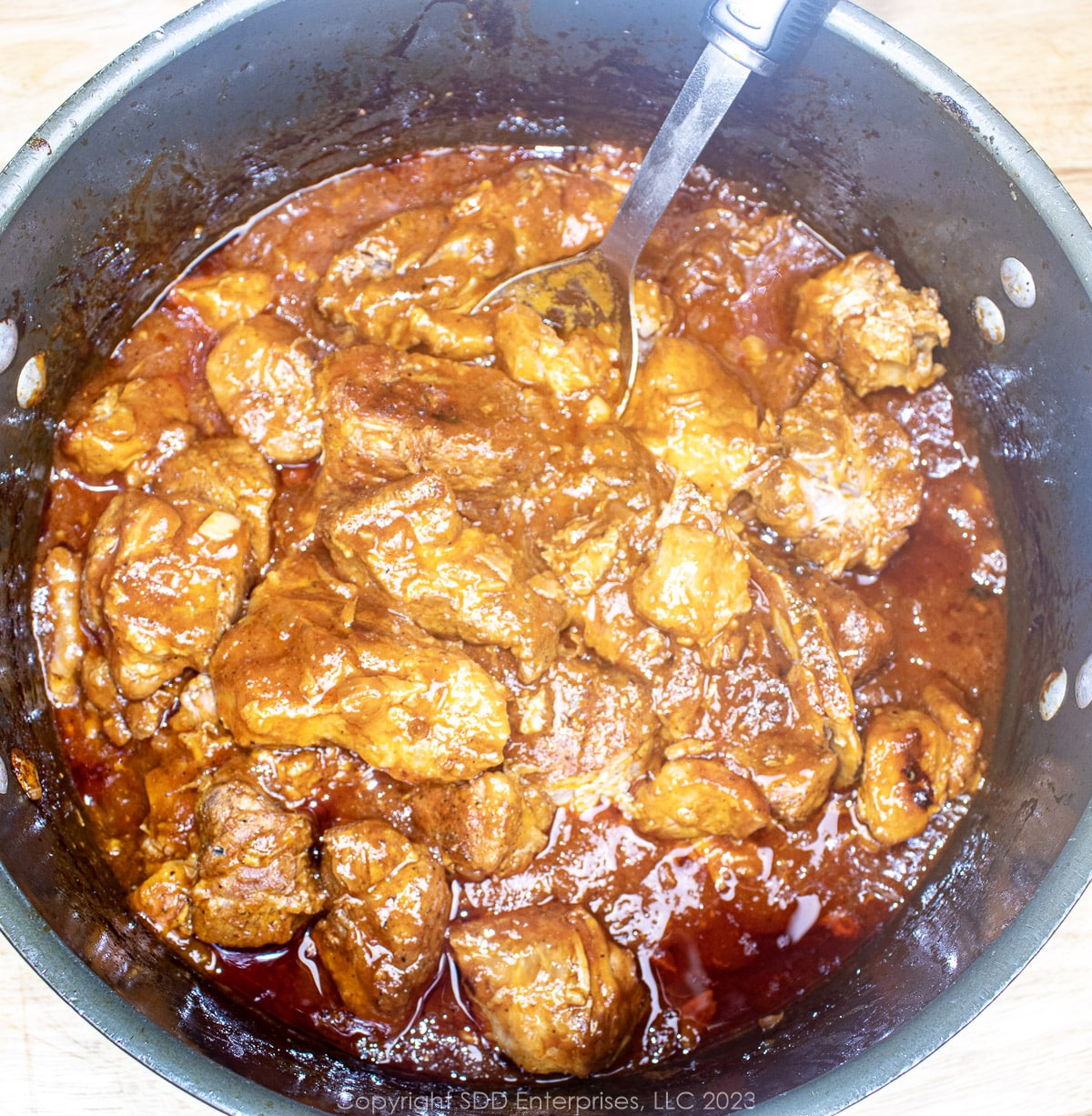 braised country style pork spareribs in a Dutch oven right out of the oven