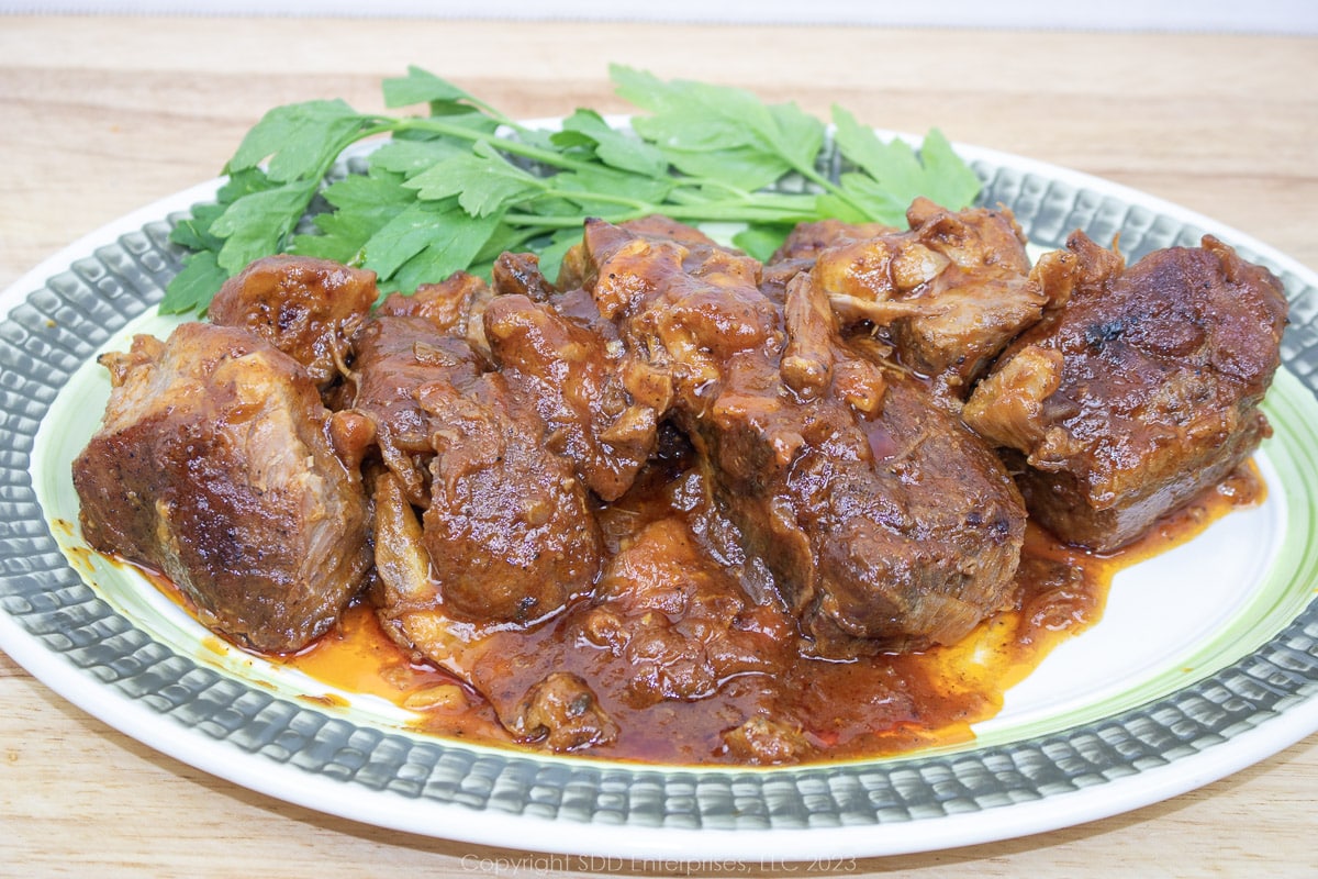 sweet and sour country-style pork spare ribs on a serving platter with garnish