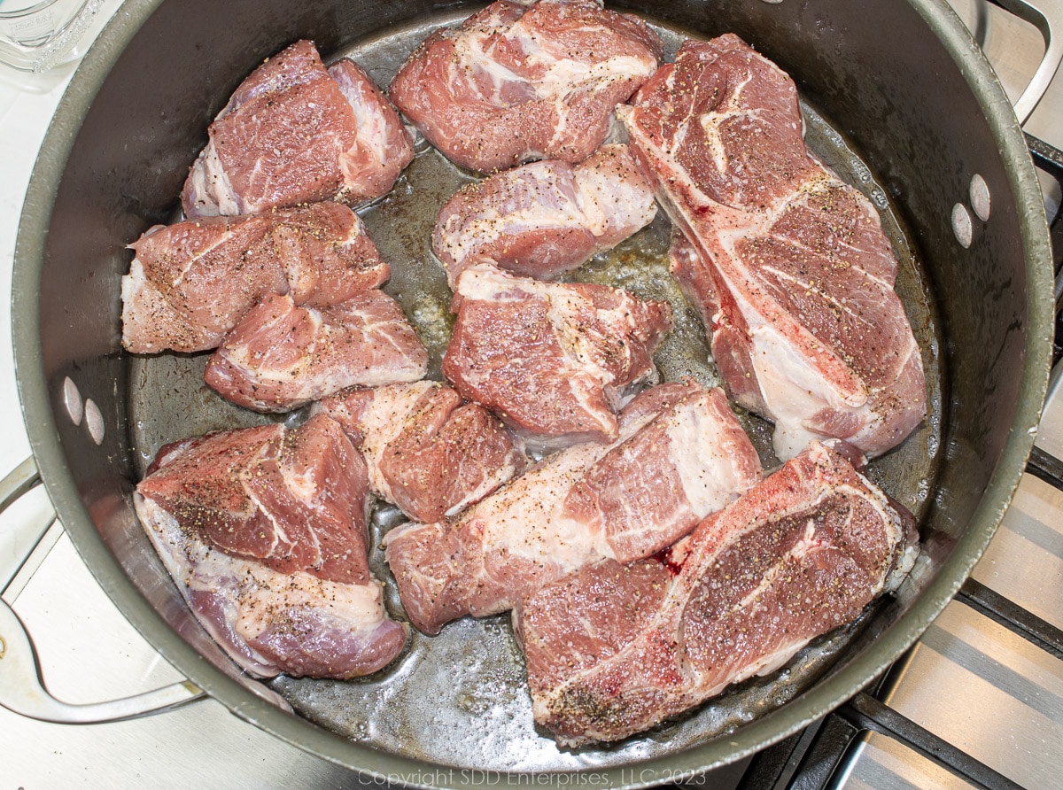 country style spareribs browning in a Dutch oven