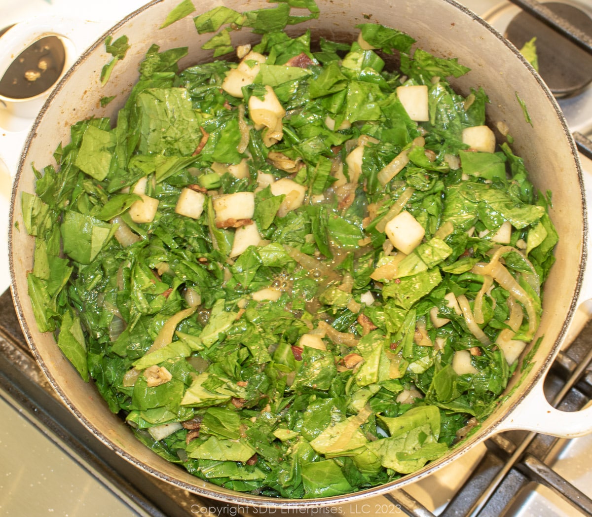 turnips, greens and seasonings simmering in a Dutch oven