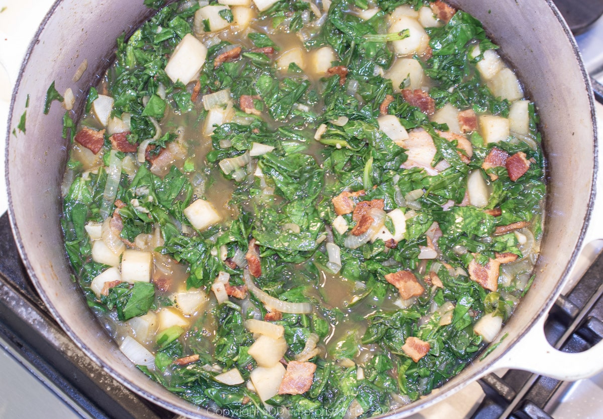 smothering turnip greens in a Dutch oven