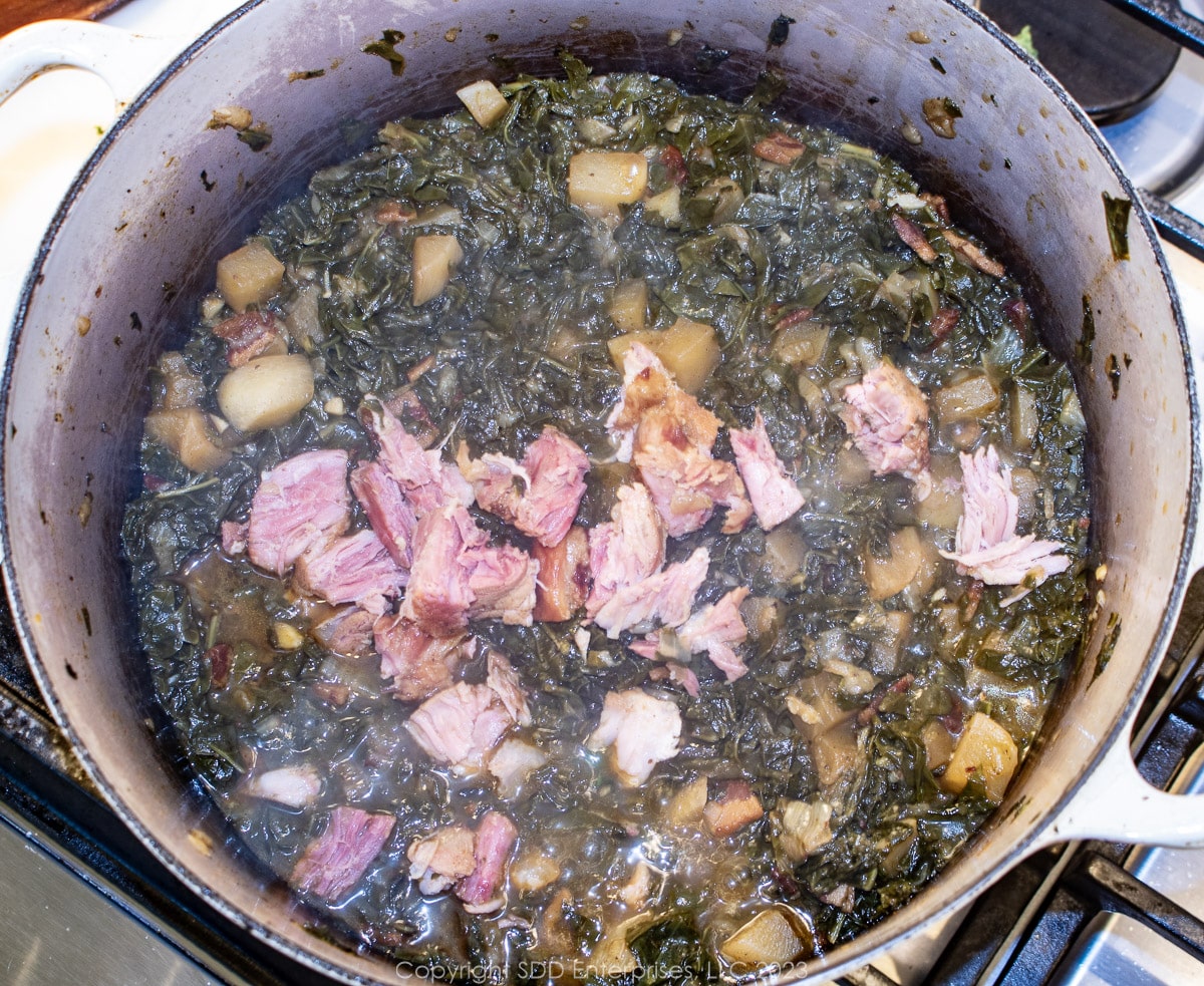 shredded ham with smothered turnip greens in a Dutch oven