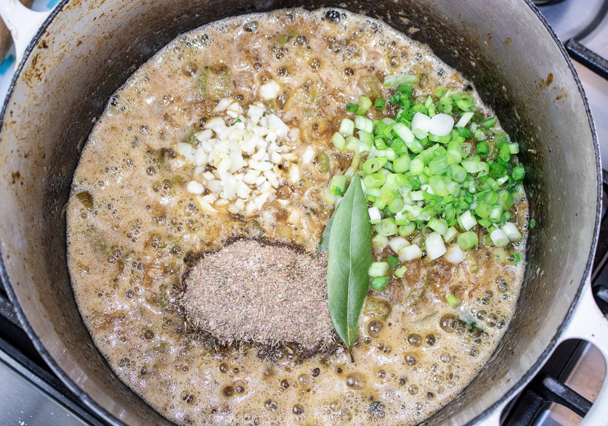 seasonings added to sautéing vegetables and flour in a Dutch oven