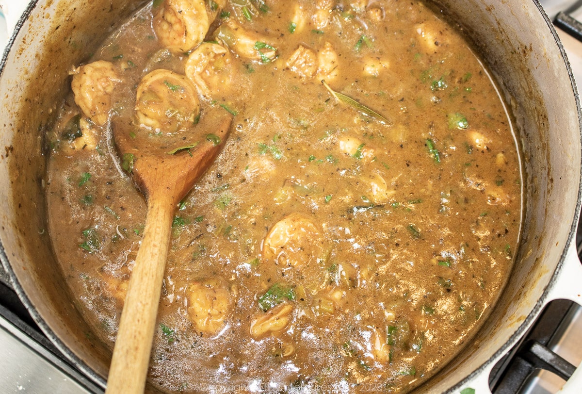 finished shrimp étouffée with a wooden spoon in a Dutch oven