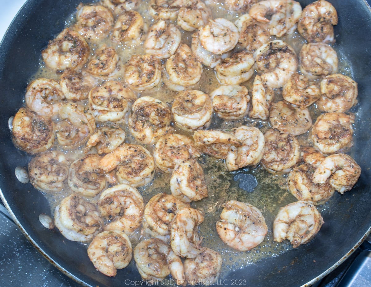 seasoned shrimp searing in a fry pan