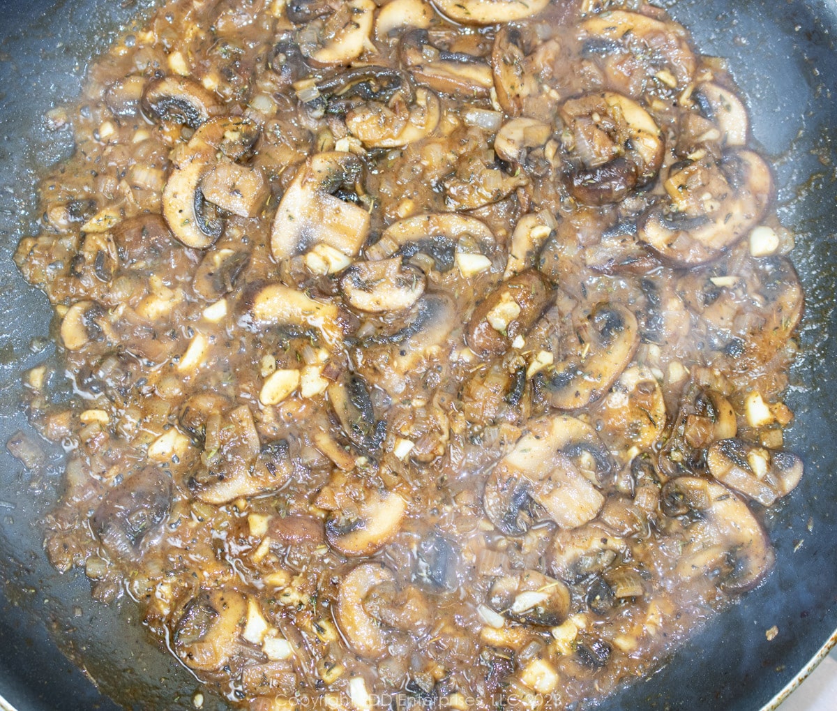mushrooms and shallots simmering with dry sherry in a skillet
