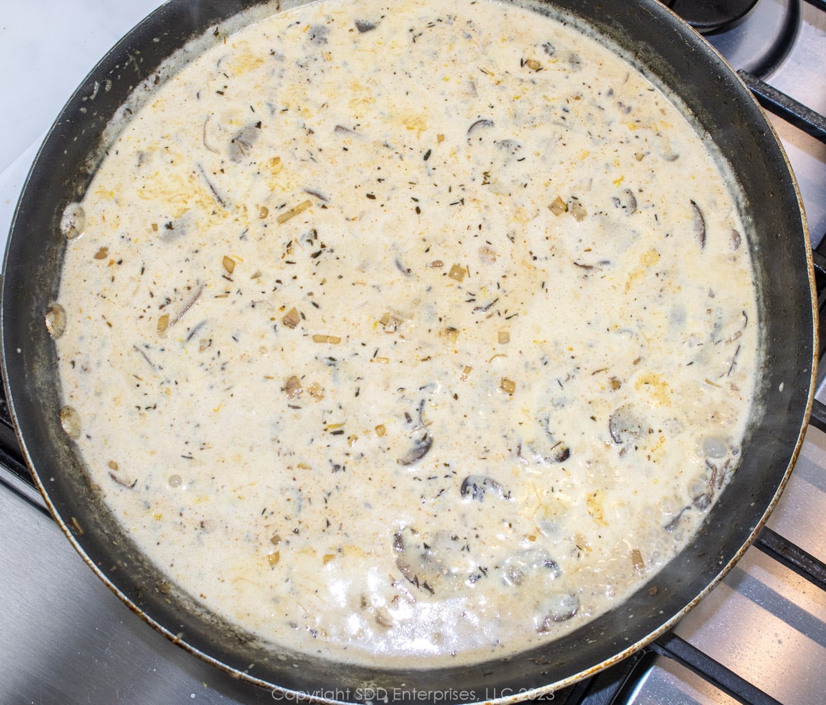 Cream sauce simmering in a skillet.