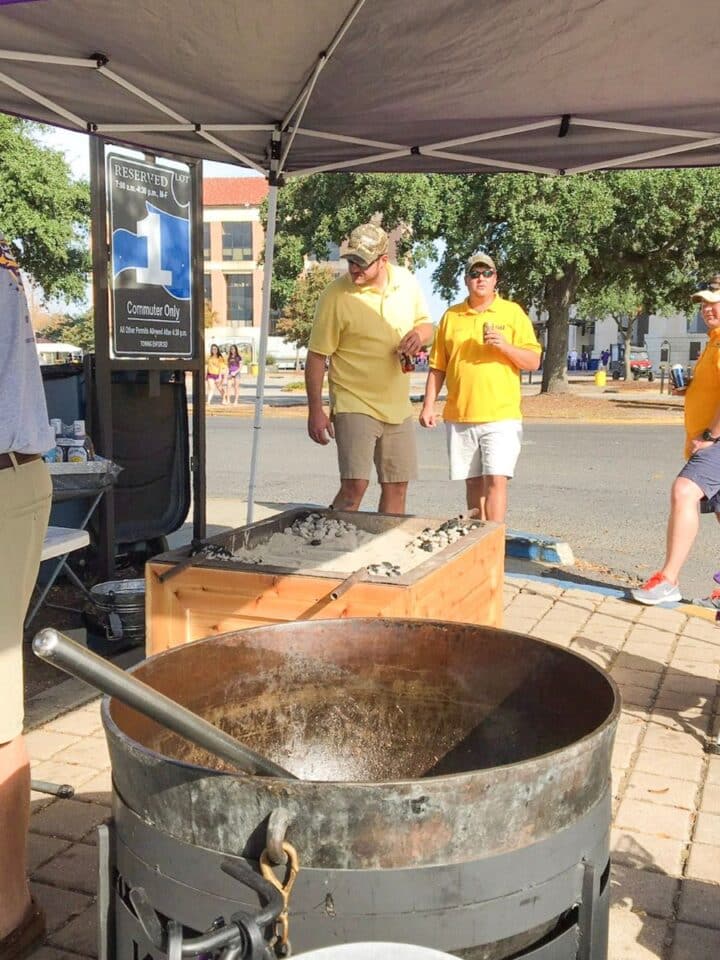 scene from a football tailgate party with a jambalaya pot