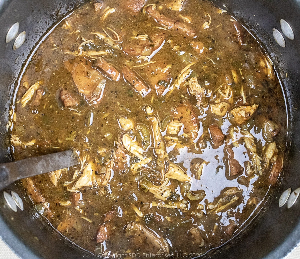 A stockpot full of Chicken and Andouille Gumbo with a label. 