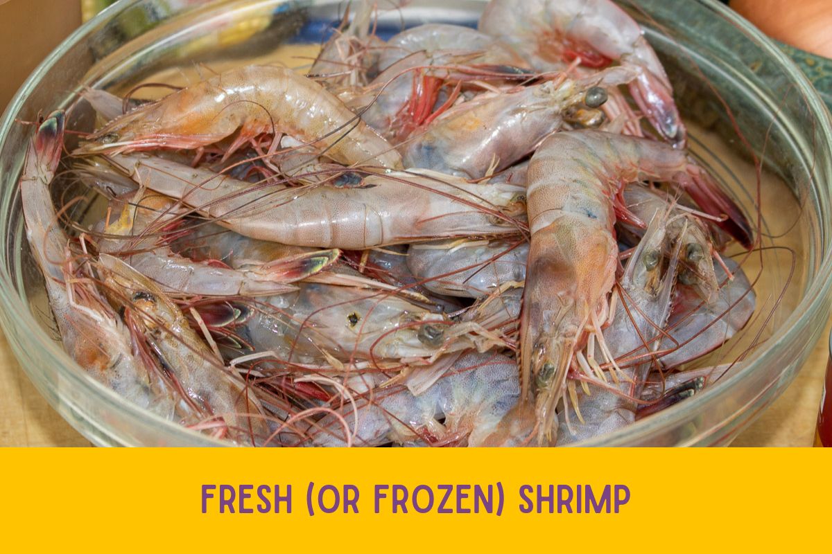 Fresh raw whole shrimp in a glass bowl.