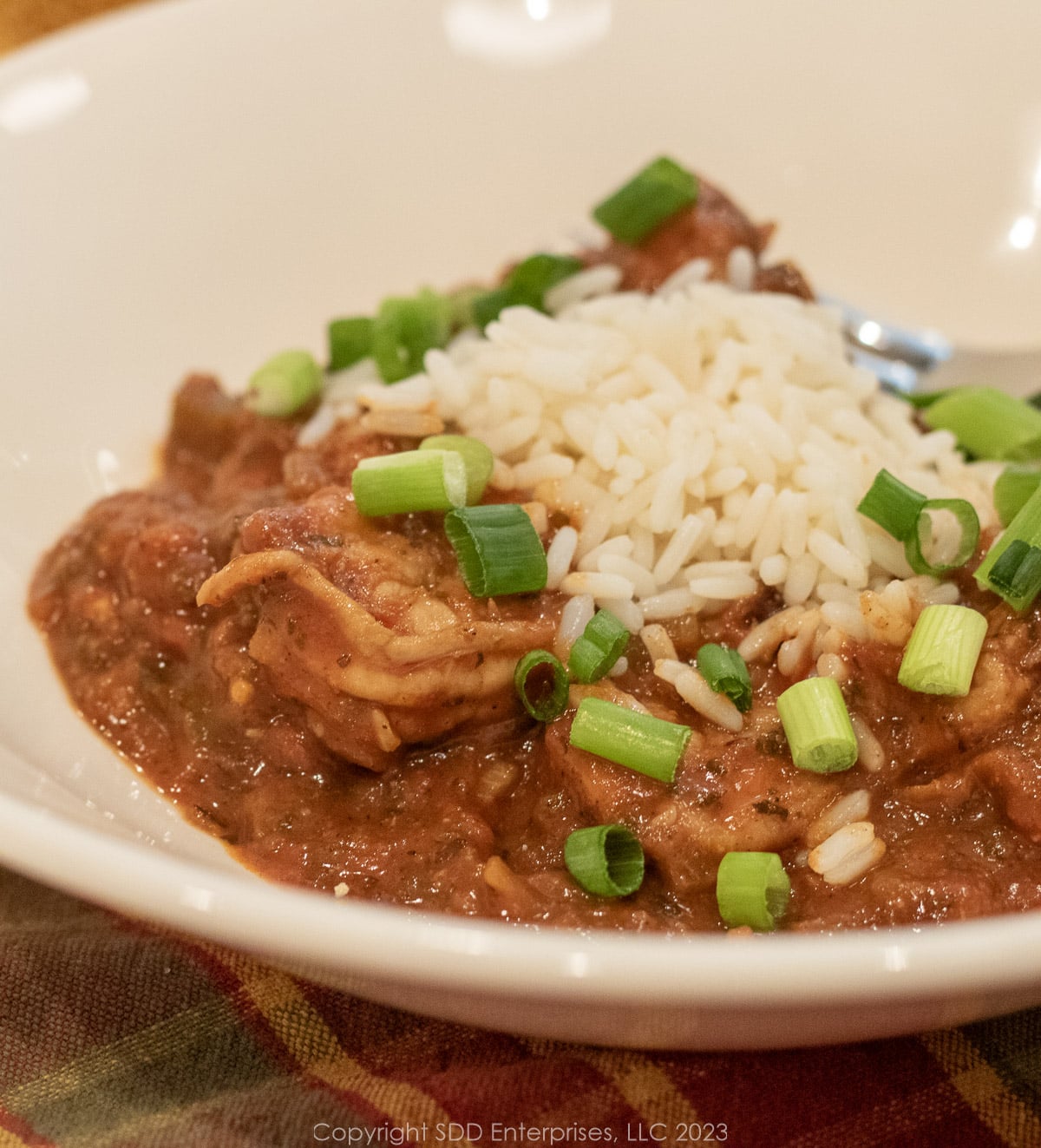 Shrimp Creole with rice and garnish in a white bowl