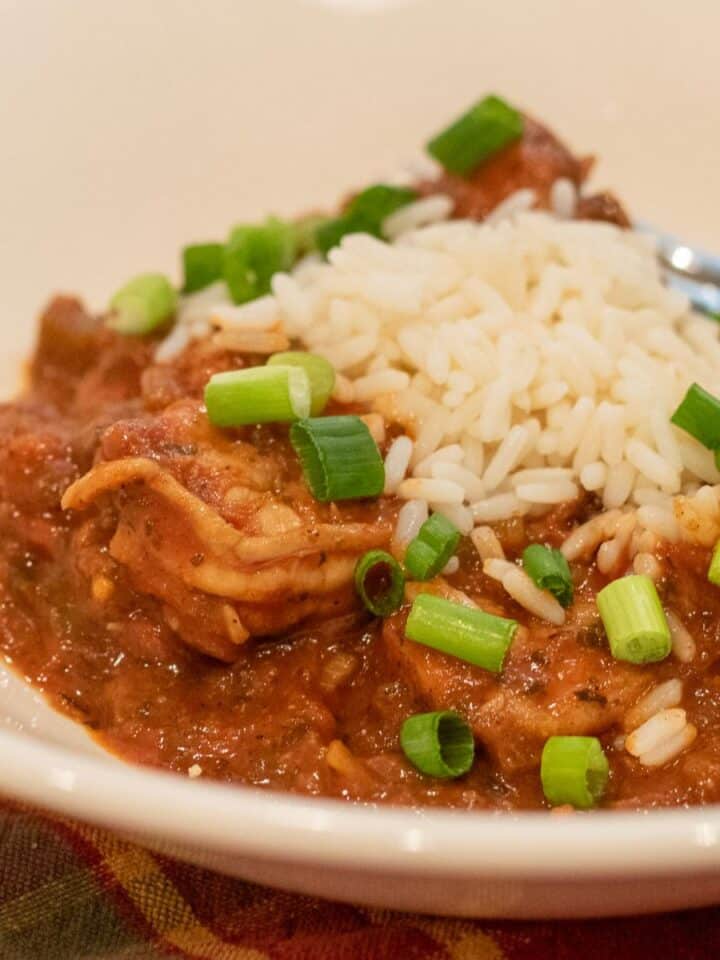 shrimp creole with rice and garnish in a white bowl