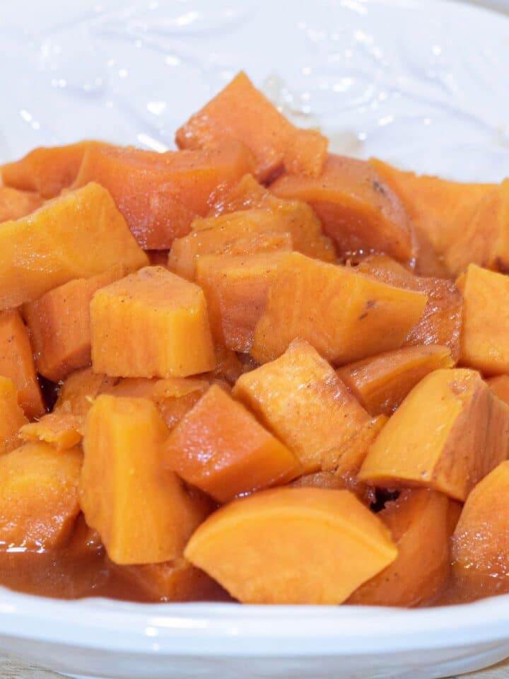 Candied Sweet Potatoes in a white serving dish.