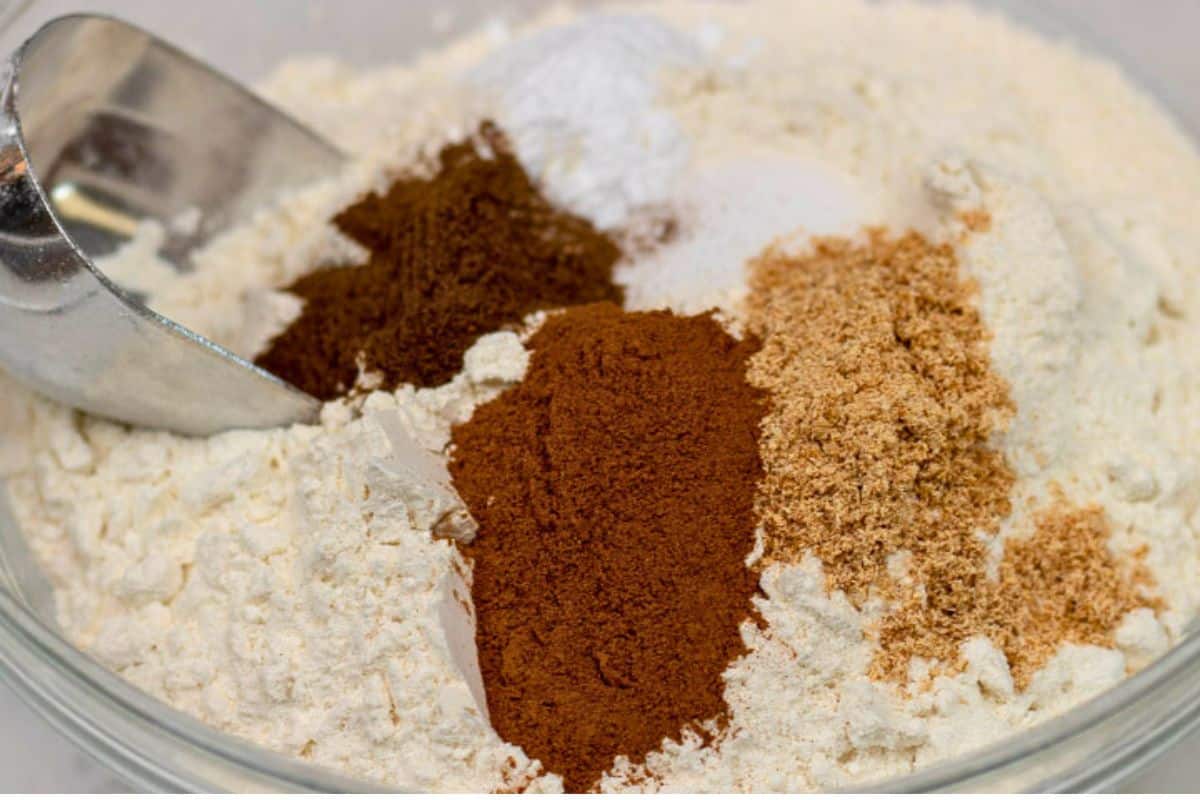 Dry ingredients for Fruitcake batter in a glass bowl.