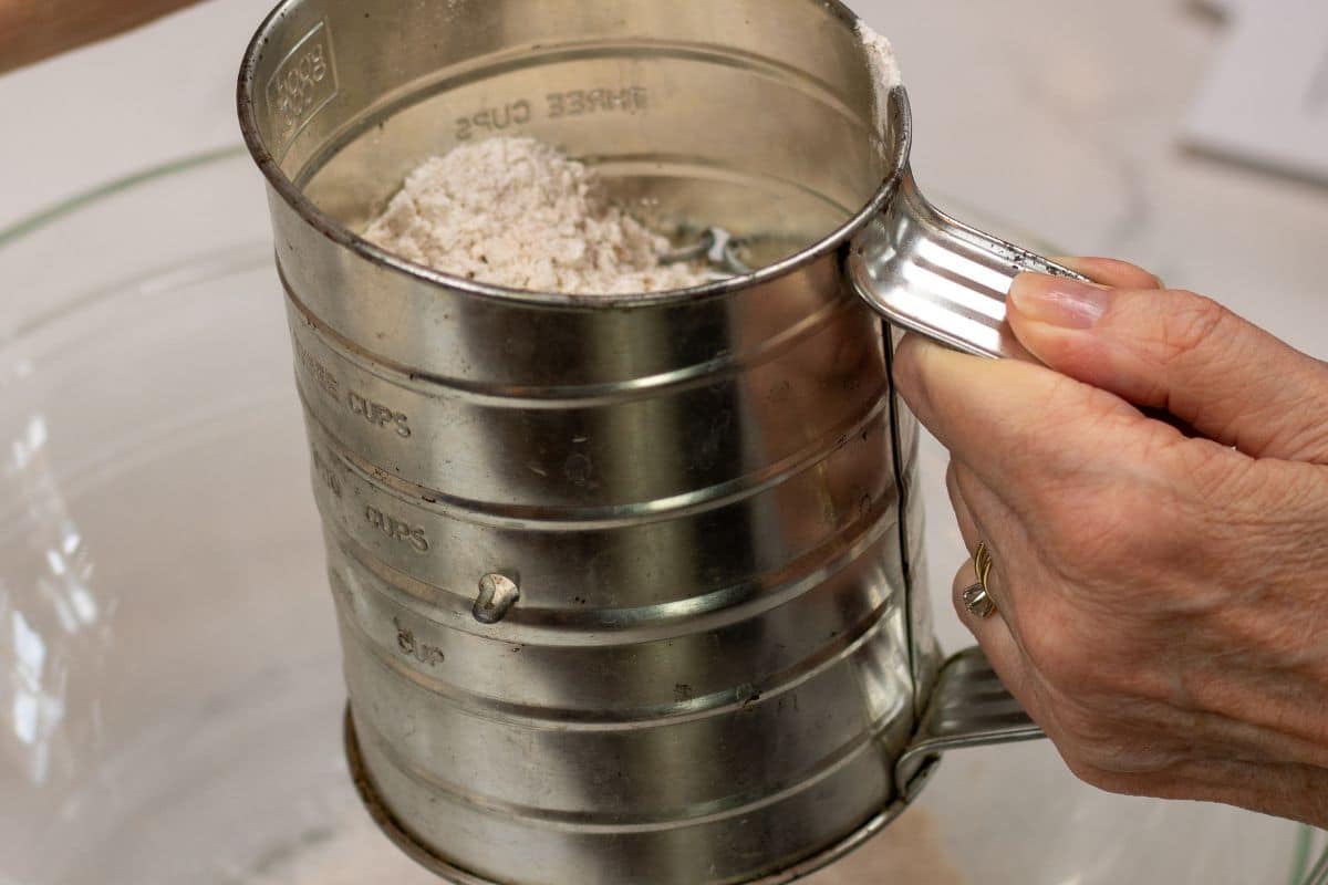 Dry ingredients for Fruitcake batter in a sifter.